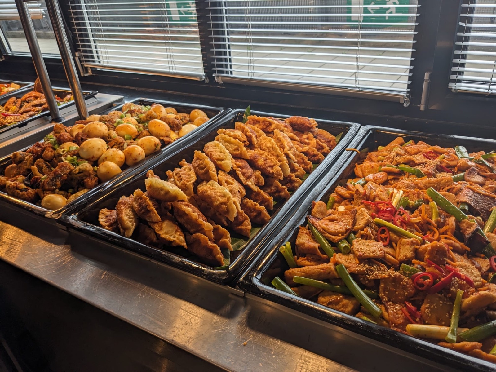Korean dumplings, braised eggs and stir-fried dishes ready for buffet service